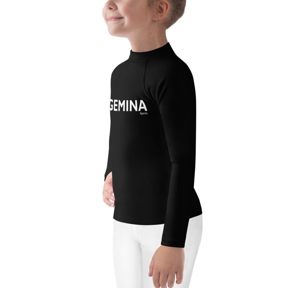 Child wearing Gemina Kids Rash Guard in black with long sleeves.