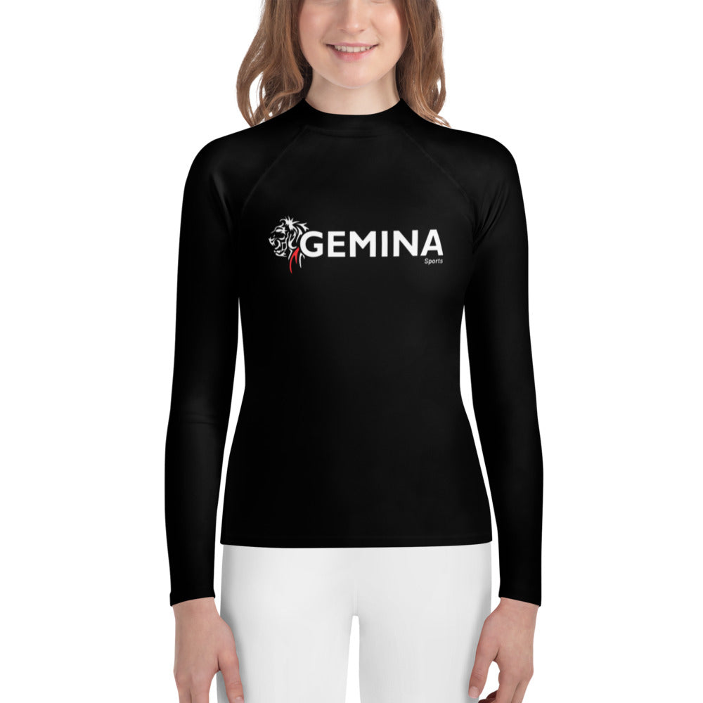 Youth wearing black Gemina Youth Rash Guard with long sleeves and fitted design.